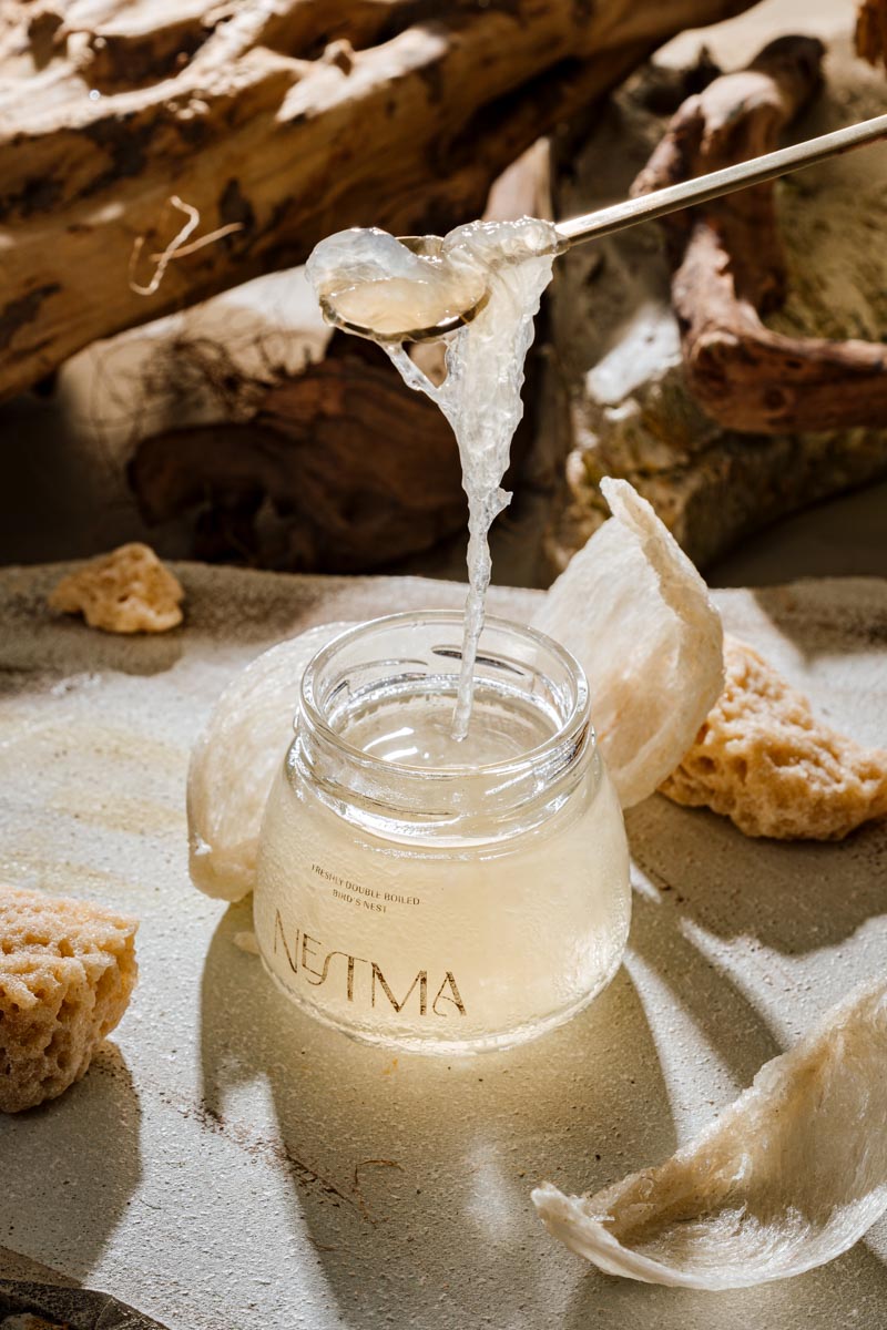 Nestma freshly double-boiled bird's nest being lifted with spoon, pure and natural